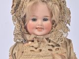 a doll that is wearing a bonnet and a dress