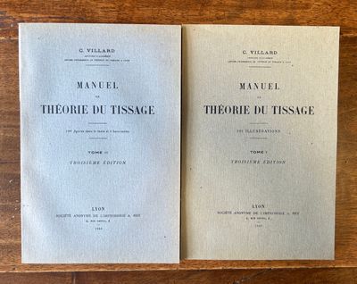 two books sitting on top of a wooden table next to each other