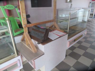 a display case in the middle of a room with a checkered floor