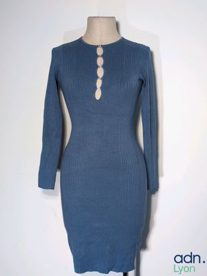 the dress is blue and has buttons on the neck