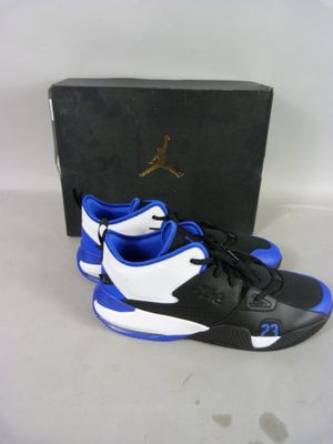 a pair of black and blue shoes sitting on top of a box
