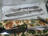 a set of silverware in a case on a table