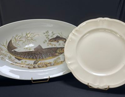 a plate with a fish on it next to a plate with a fish on it