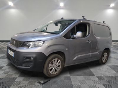 the silver van is parked on a checkered floor in a room