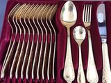 silverware in a velvet case on a table with a silverware fork and spoon