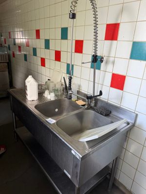 a stainless steel sink with a faucet in the middle of it