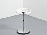 an image of a white stool in a corner of a room