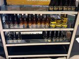 many bottles of beer on display in a store