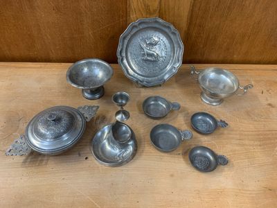 an image of a collection of pewware on a wooden table