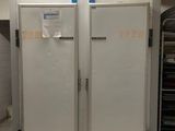 two freezers that are in a kitchen next to each other