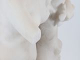 a white statue of a boy and a girl holding hands