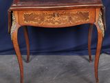 a small wooden table with a drawer on top of it