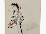 a drawing of a woman ' s face on a canvas