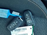 two car keys and a barcode sitting on the seat of a car