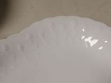 a white plate with a decorative design on it
