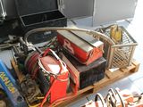 un tas d'outils posés sur une palette dans un garage