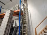 a ladder that is leaning against a wall in a warehouse