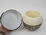 a person holding a white bowl and a white cup