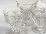 four wine glasses sitting on a table with a white background