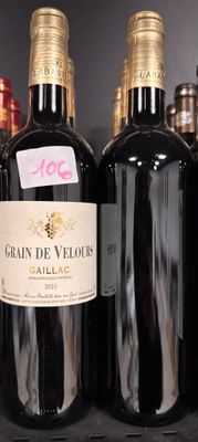 several bottles of wine sit on a shelf in a store