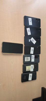 a wall with a bunch of different cell phones on it
