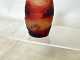 a vase that is sitting on a clear shelf