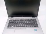 an open laptop computer sitting on top of a white table