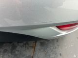a close up of the rear end of a car with scratches on it