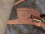a close up of a brown and black bag with a name tag on it