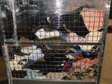 a large metal cart with a lot of clothes on it