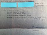 an old document with a piece of blue paper taped to it