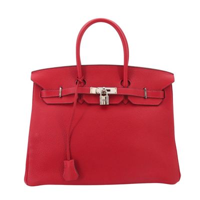 a red leather handbag on a white background