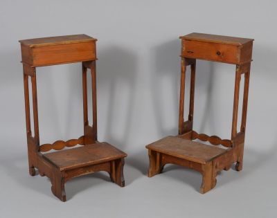 pair of antique wooden stools with a drawer on each of them