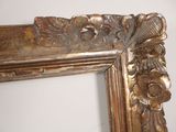 a picture of a mirror with a gold frame on the wall