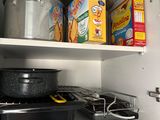 many pots and pans on the shelves in the kitchen