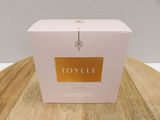 a close up of a box of perfume on a wooden table