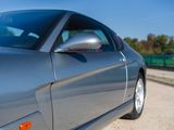 a silver sports car parked on the side of the road