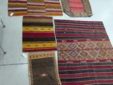 several different rugs are laid out on the floor in a room
