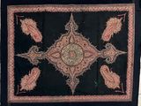 an image of a black and red rug with paisley designs on it
