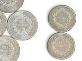 a lot of coins that are on a white surface