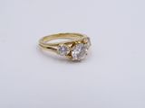 a close up of a gold ring with two diamonds on it