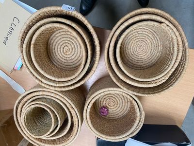 several baskets are stacked on top of each other on a table