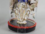 a vase with flowers in it under a glass dome