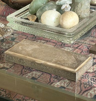 a glass table with a tray of rocks and other items on it
