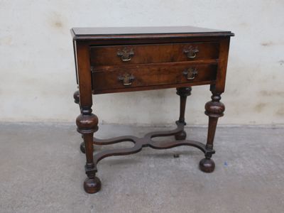 a small wooden table with a drawer on top of it
