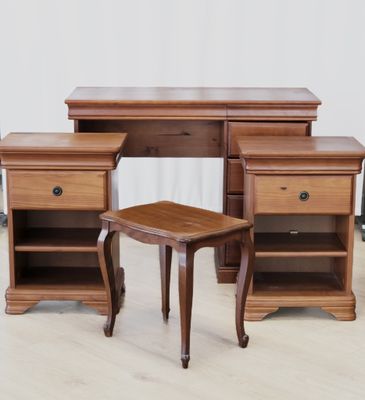 a wooden desk with two drawers and a small stool