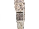 sculpture of a wooden head on a black stand on a white background