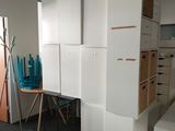 a room with white cabinets and a brown couch in it