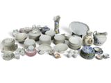 many different types of dishes and cups on the table