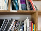 a bookshelf with many books on it in a room